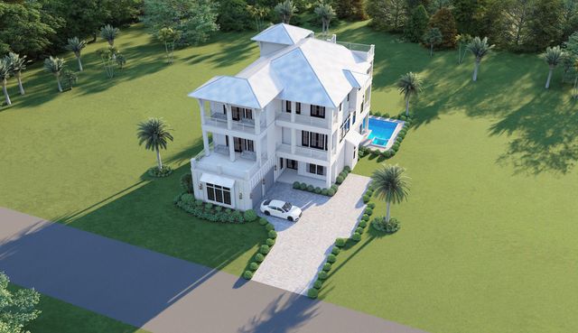 an aerial view of a house with a yard and lake view