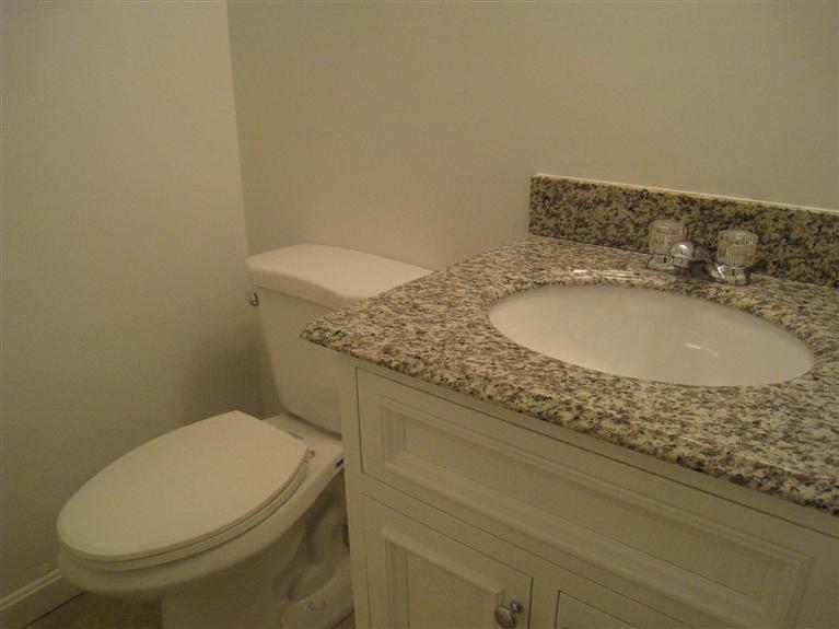 22 Quisset Road Centerville, MA 02632 - Photo 9 of 19 a bathroom with a granite countertop toilet and a sink