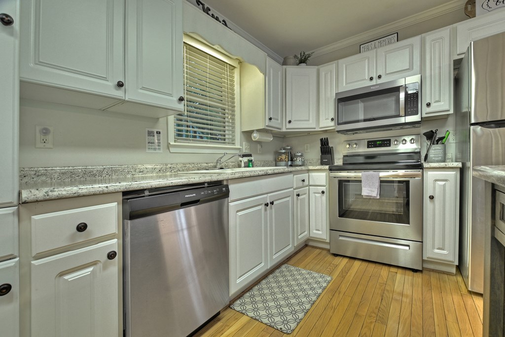53 Addle Trail Ellijay, GA 30540 - Photo 12 of 50 a kitchen with stainless steel appliances granite countertop a stove a sink and a microwave