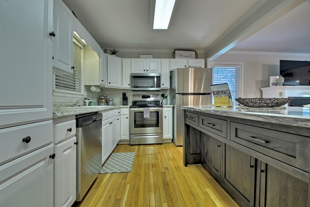 53 Addle Trail Ellijay, GA 30540 - Photo 14 of 50 a kitchen with kitchen island granite countertop a sink appliances cabinets and counter space
