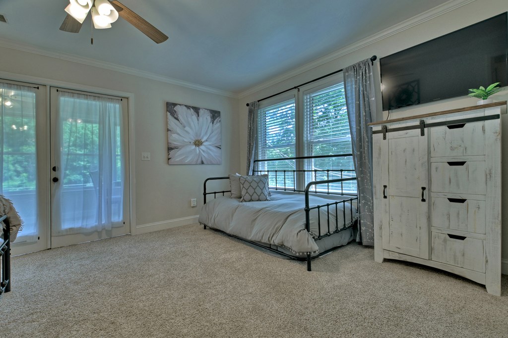 53 Addle Trail Ellijay, GA 30540 - Photo 26 of 50 a spacious bedroom with a bed and a chandelier