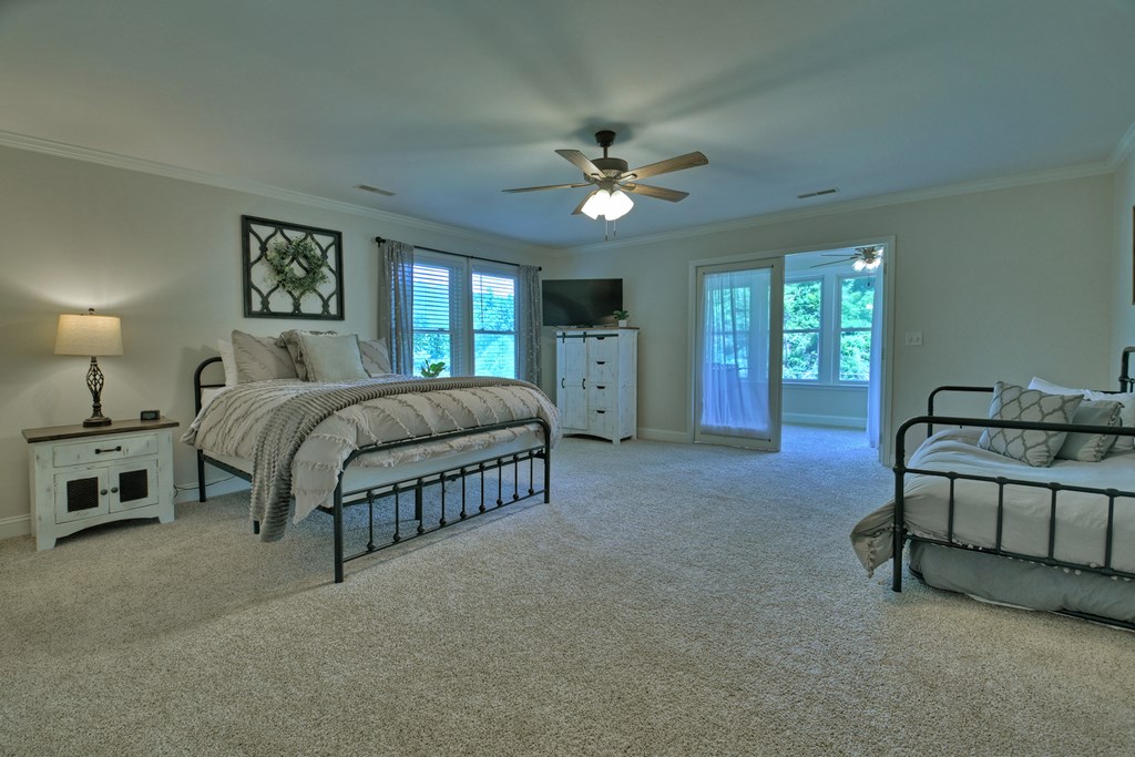 53 Addle Trail Ellijay, GA 30540 - Photo 32 of 50 a spacious bedroom with a bed a couch and dresser