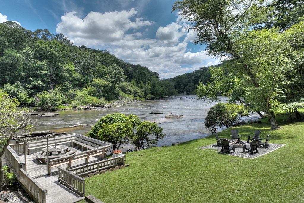 53 Addle Trail Ellijay, GA 30540 - Photo 46 of 50 a view of a backyard with table and chairs and a fire pit