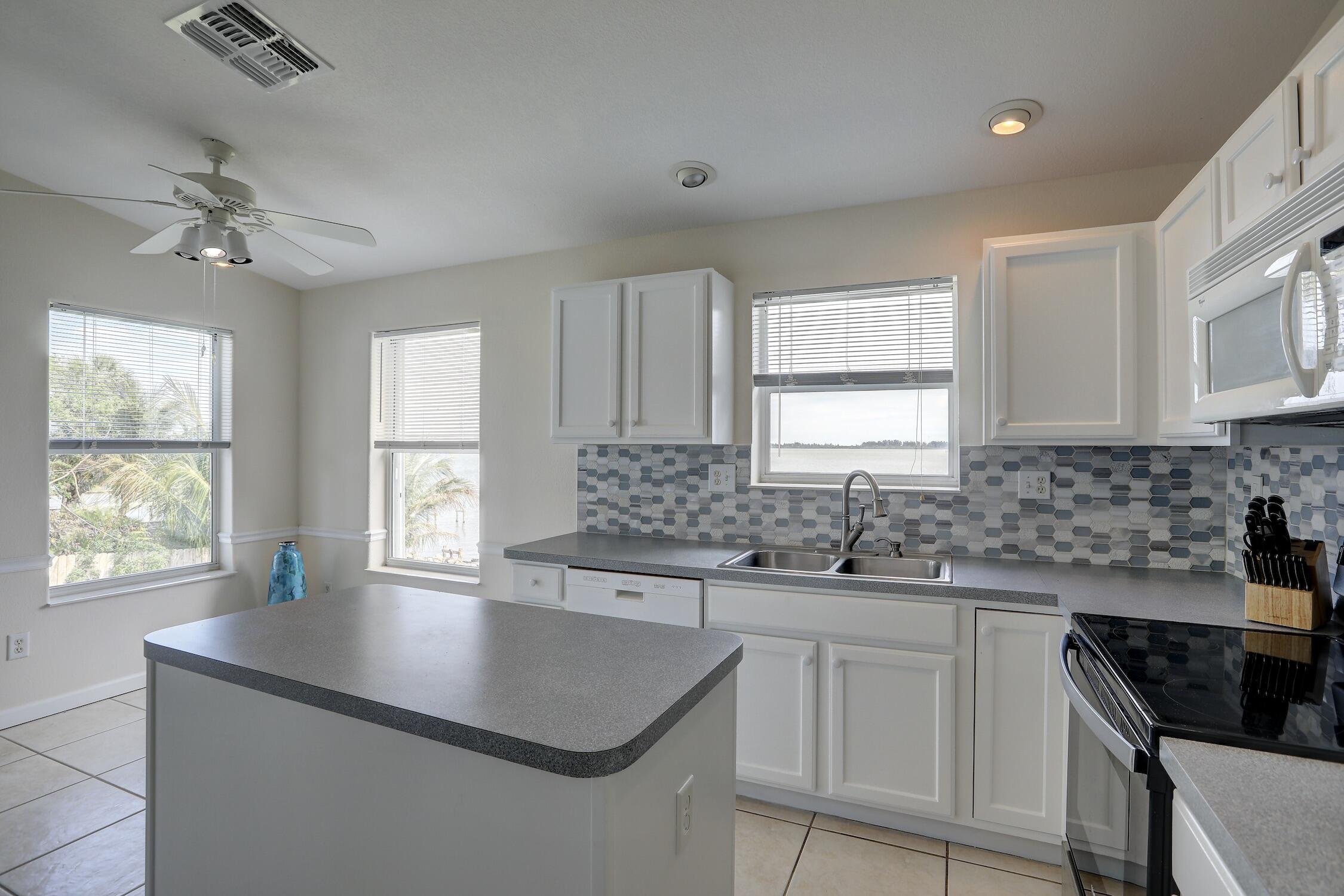 8825 Highway 1 Micco, FL 32976 - Photo 16 of 32 a kitchen with a sink a window and cabinets
