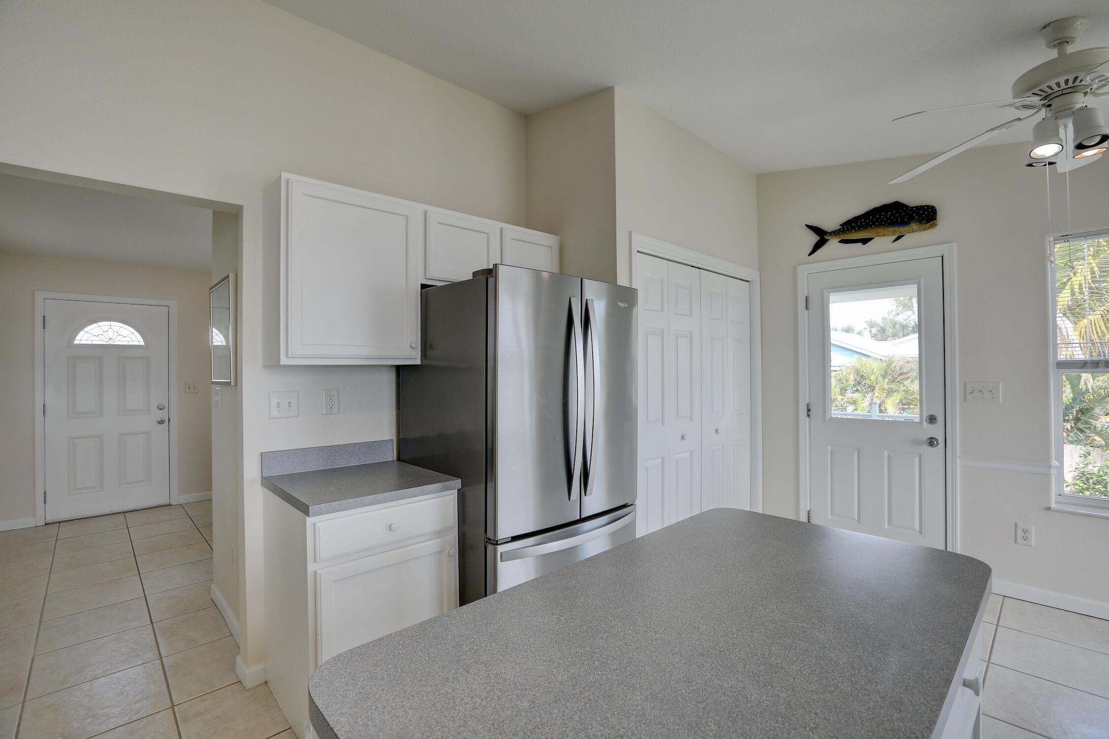 8825 Highway 1 Micco, FL 32976 - Photo 17 of 32 a kitchen with a refrigerator and a sink