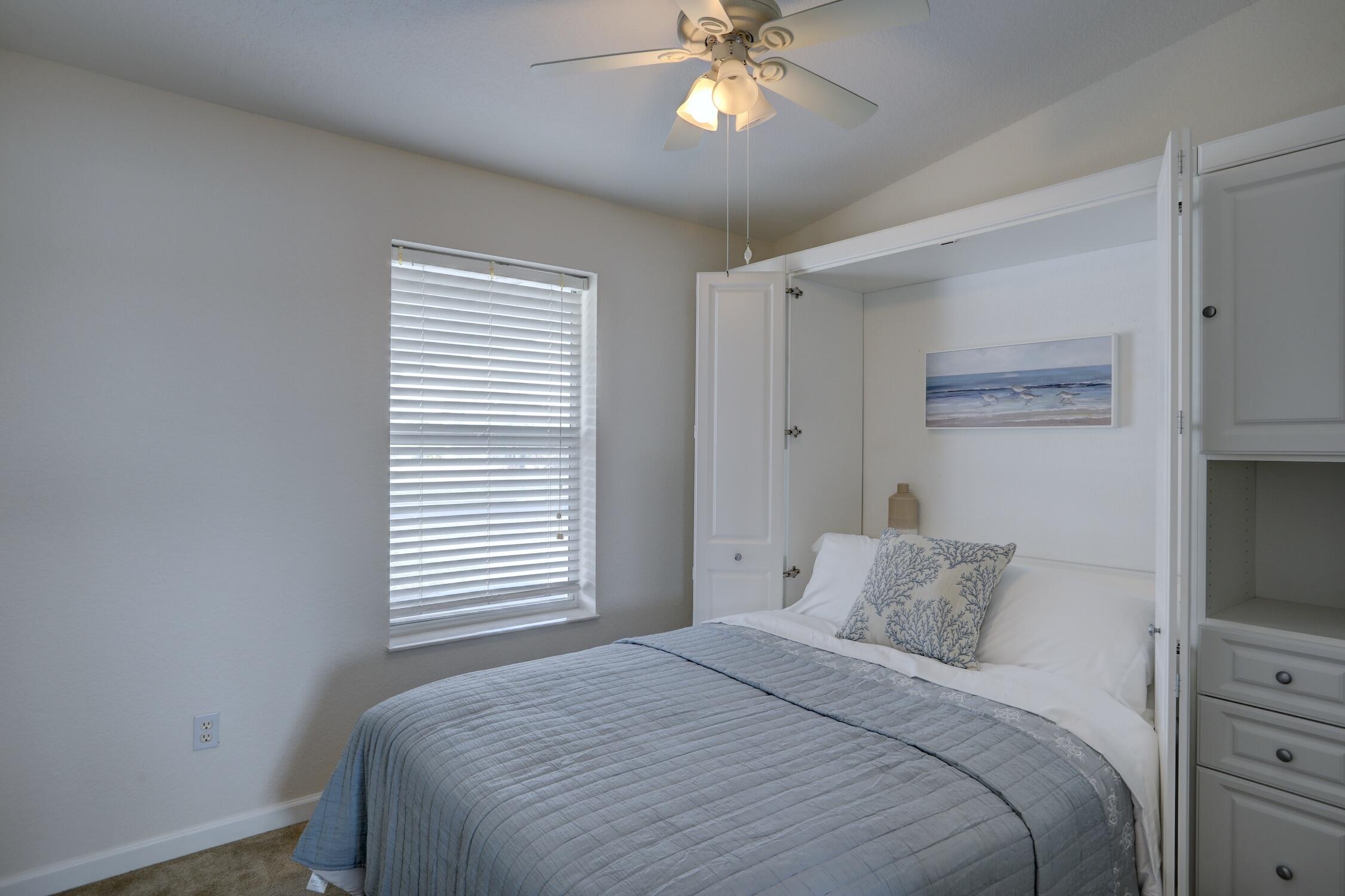 8825 Highway 1 Micco, FL 32976 - Photo 21 of 32 a bedroom with a large bed and a chandelier
