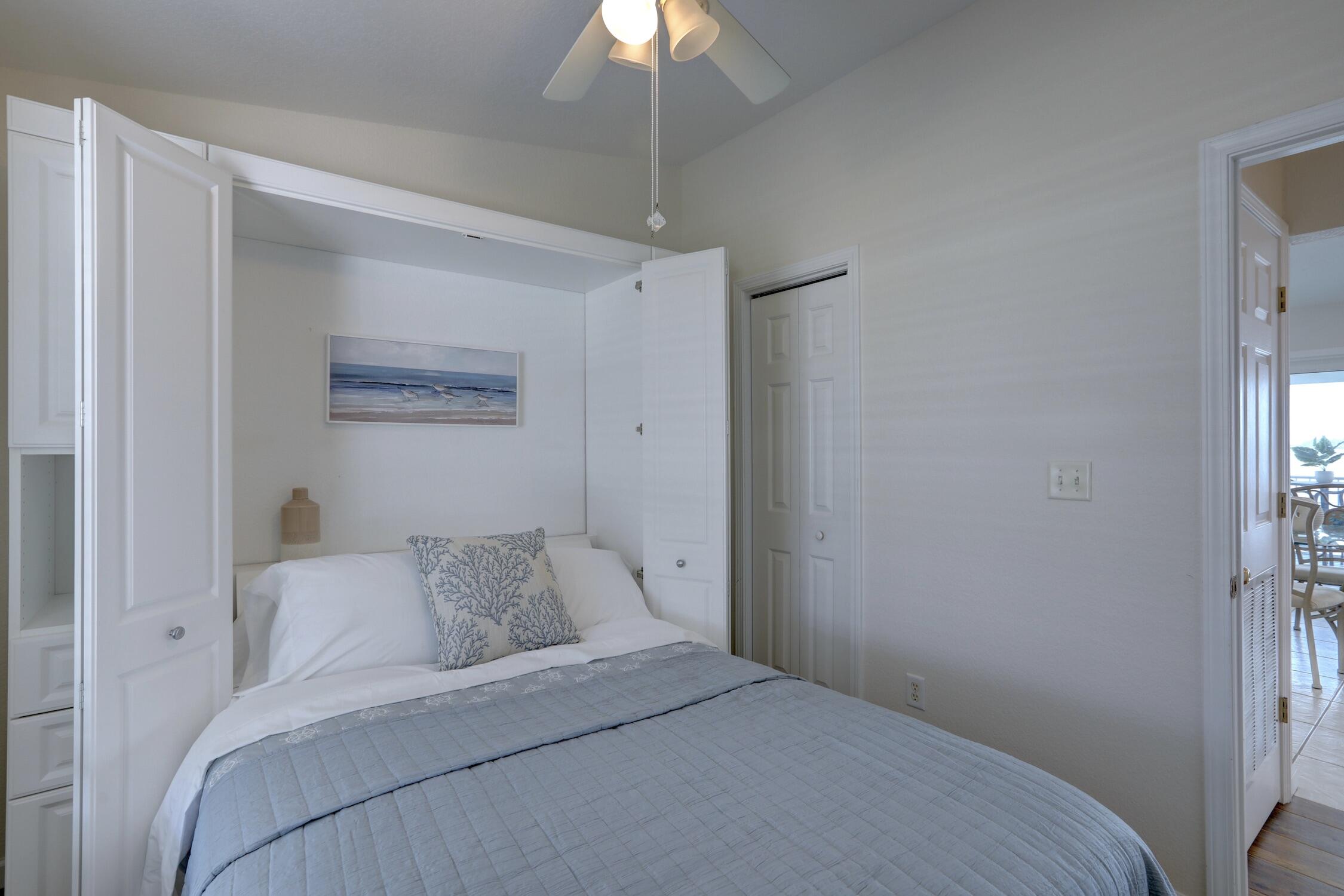 8825 Highway 1 Micco, FL 32976 - Photo 22 of 32 a bedroom with a bed and a chandelier