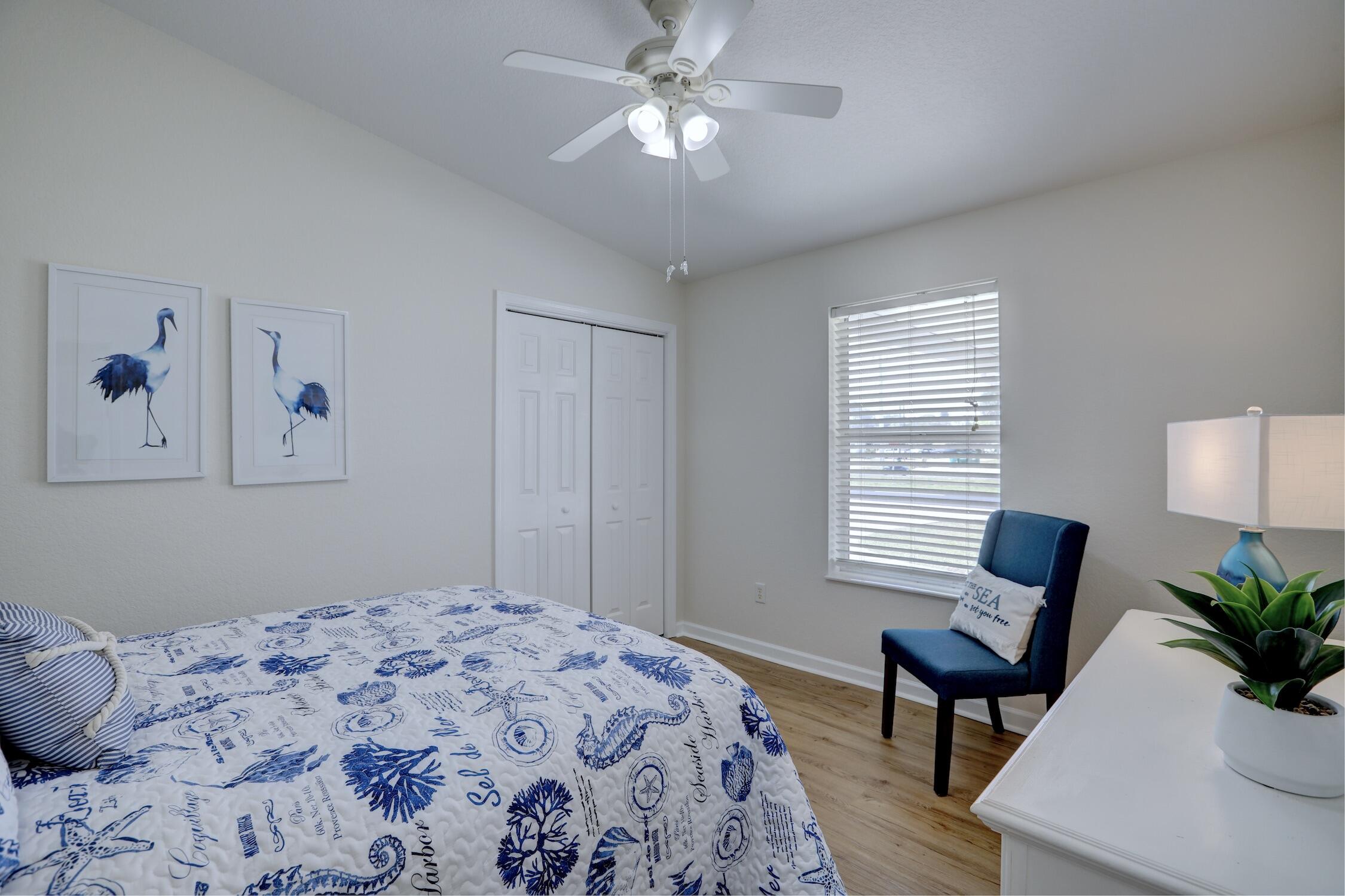 8825 Highway 1 Micco, FL 32976 - Photo 23 of 32 a bedroom with a bed and a chandelier