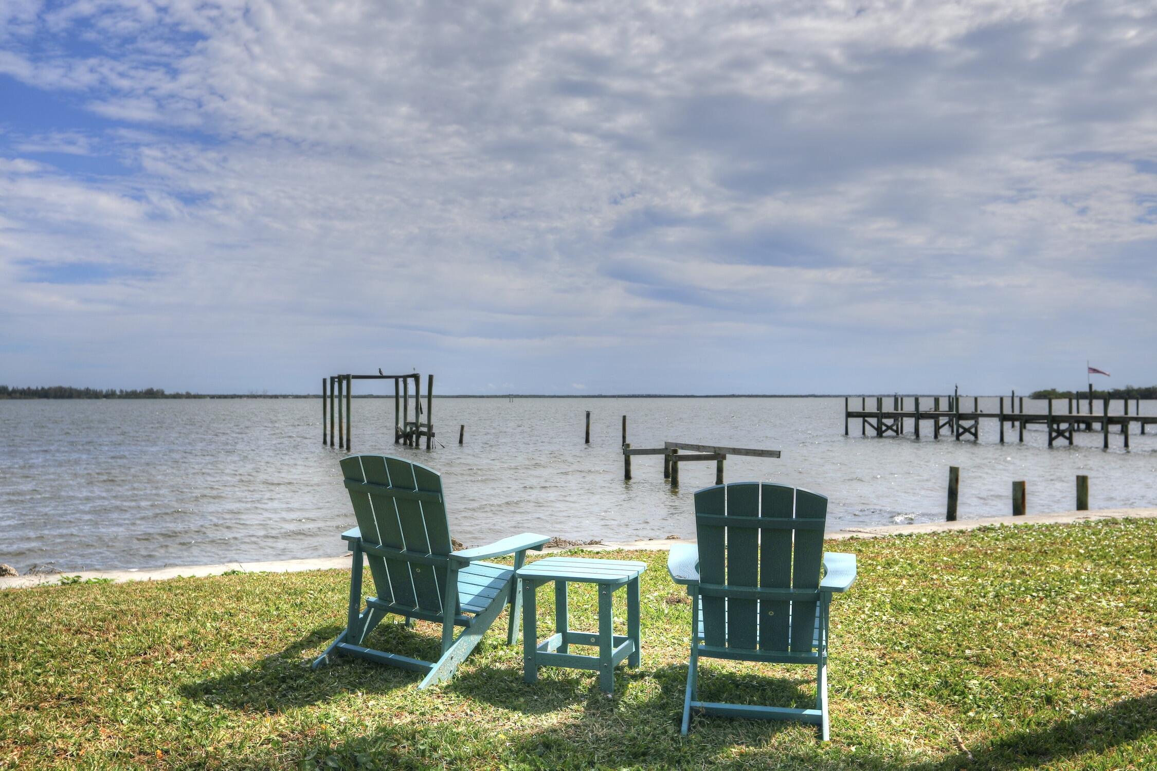8825 Highway 1 Micco, FL 32976 - Photo 31 of 32 a view of a swimming pool with a lawn chairs and a yard
