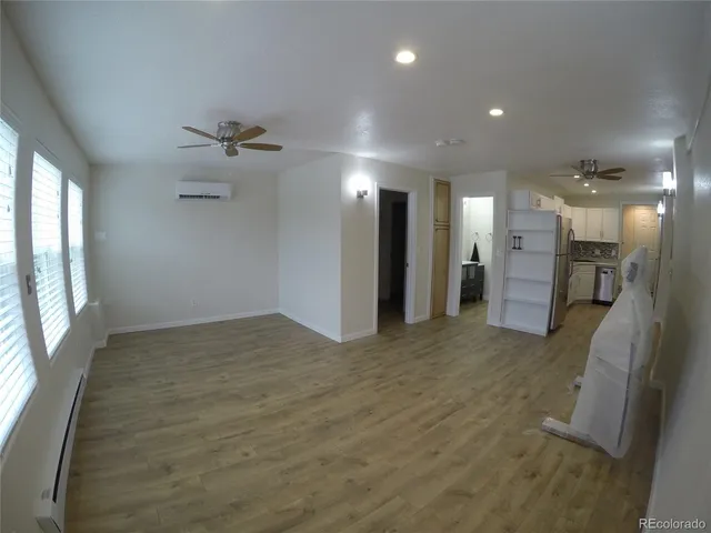 a bathroom with a sink a mirror a vanity and a toilet