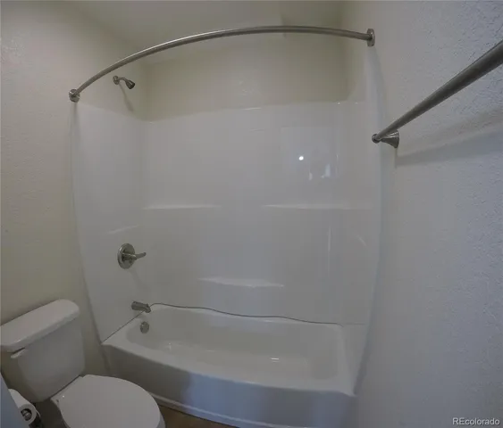 a bathroom with a shower and toilet