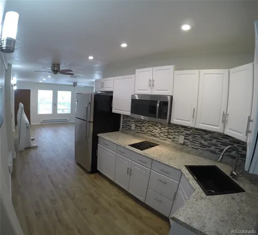a kitchen with a stove and a refrigerator