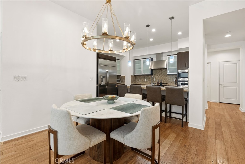 21 Gramercy, Unit 102 Irvine, CA 92612 - Photo 6 of 30 Elegant dining space seamlessly connected to the kitchen and living areas for easy entertaining.