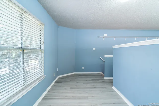 a view of a room with wooden floor and window