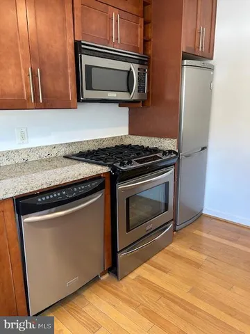 a kitchen with granite countertop cabinets and steel stainless steel appliances