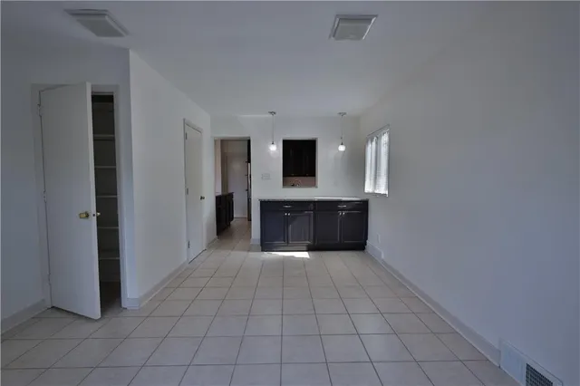 a view of an empty room with windows