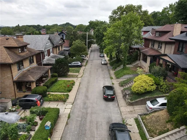 an aerial view of multiple houses with yard