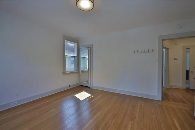 wooden floor in an empty room with a window