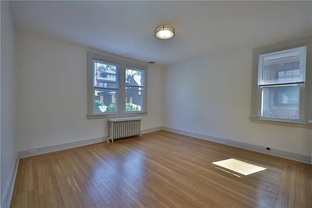 a view of walk in closet with empty racks