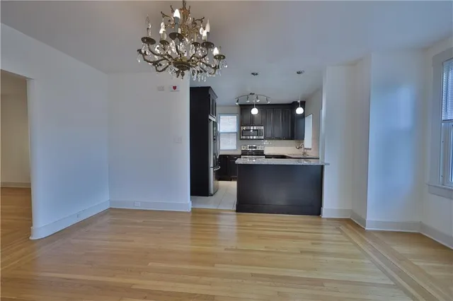 a kitchen with stainless steel appliances granite countertop a refrigerator stove and microwave