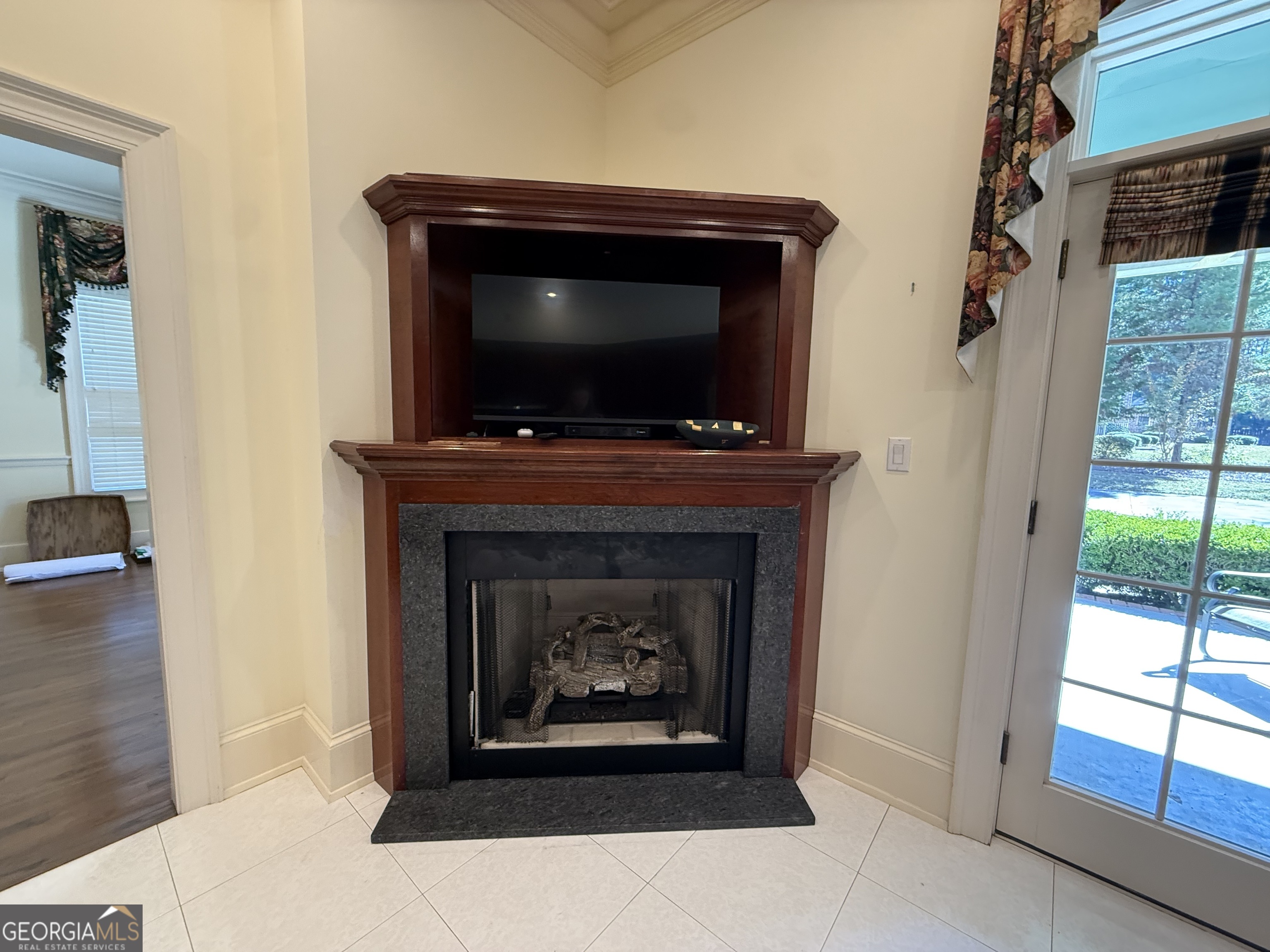 113 Parks Ridge Road Dublin, GA 31021 - Photo 30 of 99 a living room with a fireplace and a flat screen tv