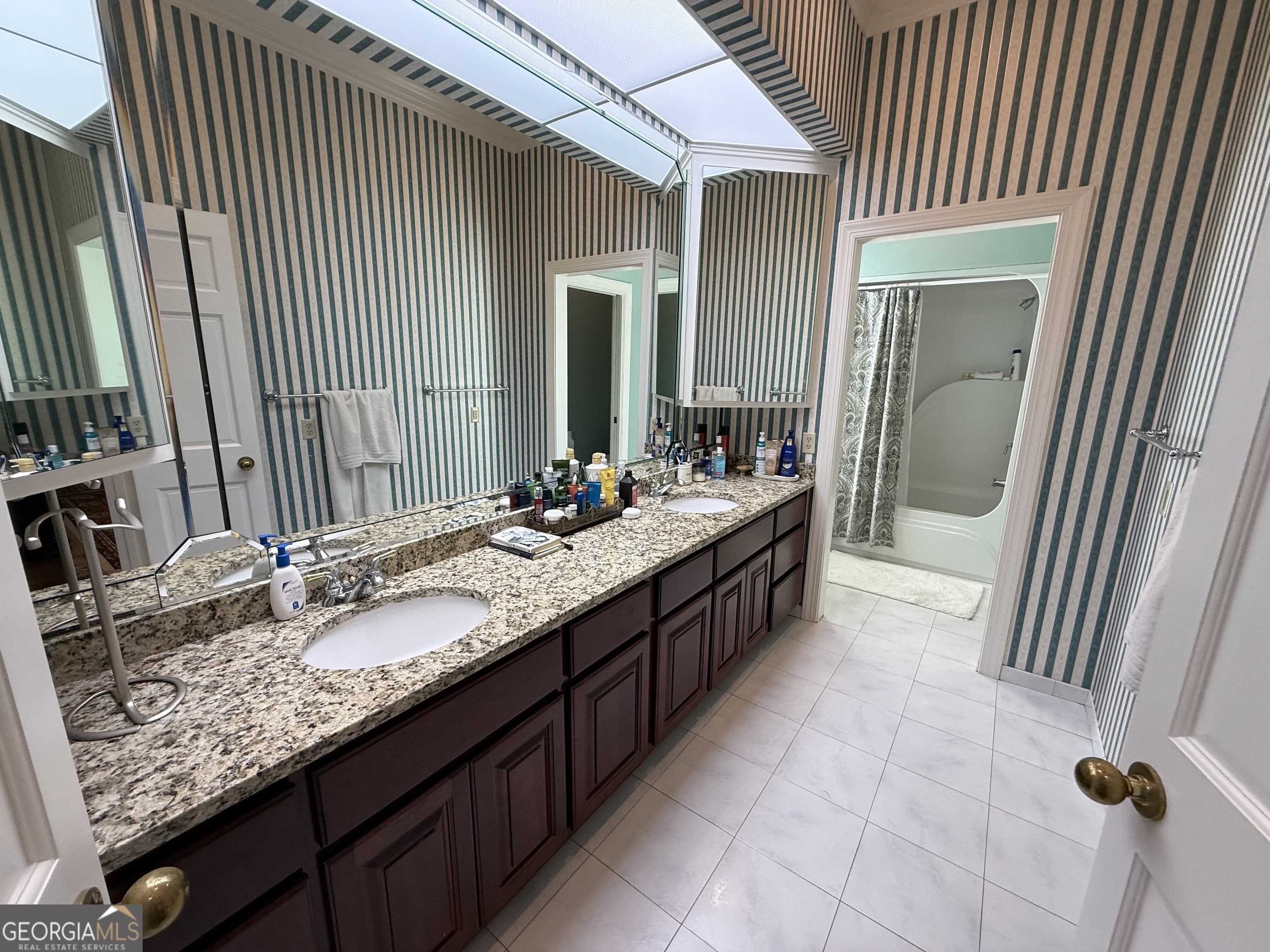 113 Parks Ridge Road Dublin, GA 31021 - Photo 65 of 99 a bathroom with a granite countertop sink a mirror and shower