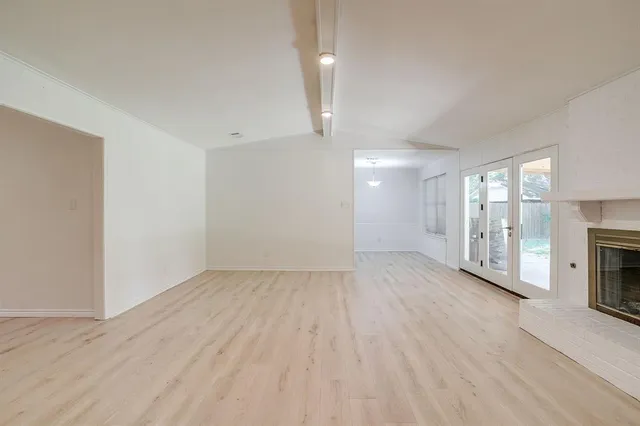 wooden floor in an empty room with a fireplace