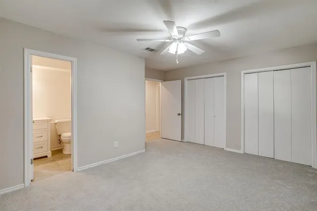 a view of an empty room and a bathroom