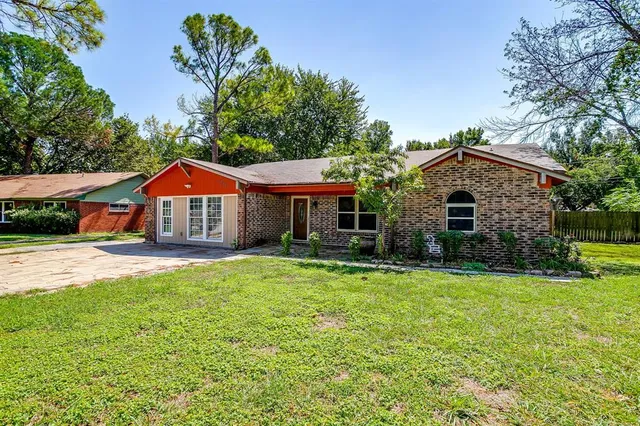 a front view of house with yard and green space
