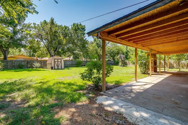 a view of a backyard with swimming pool