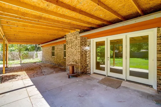 a view of a room with wooden floor and iron stairs