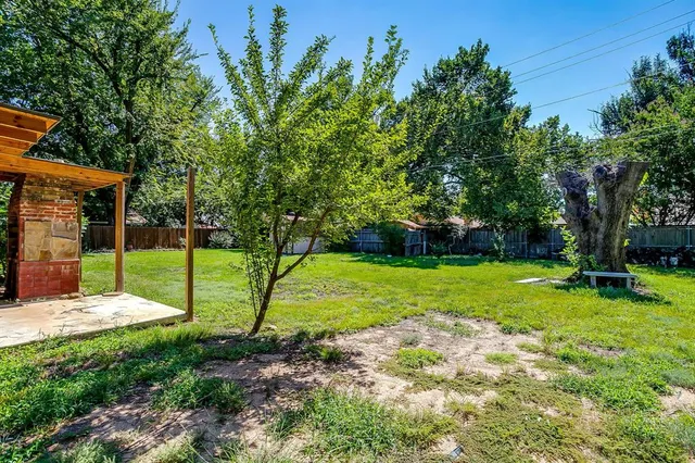 a view of a backyard with a table and chairs