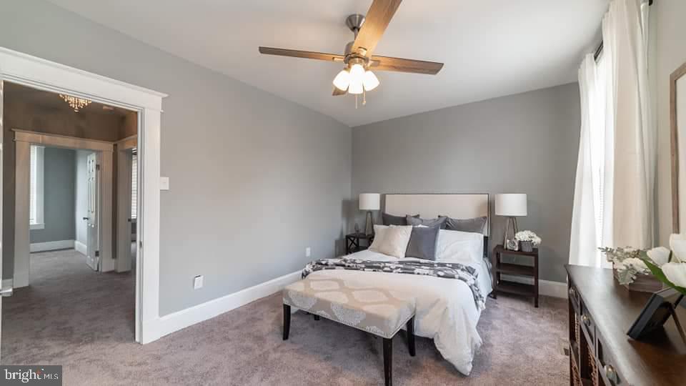 310 Marydell Road Baltimore, MD 21229 - Photo 12 of 26 a bedroom with a bed and a chandelier