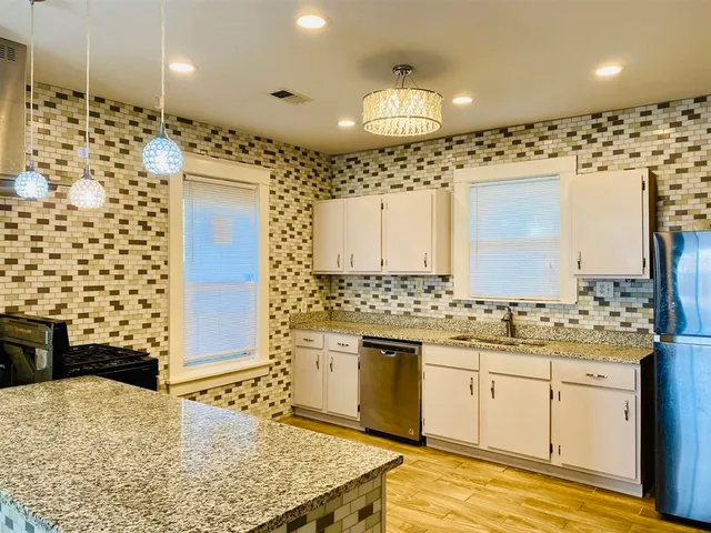 a bathroom with a sink a toilet a mirror and shower