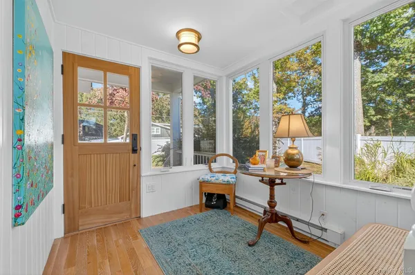 a living room with furniture and a floor to ceiling window