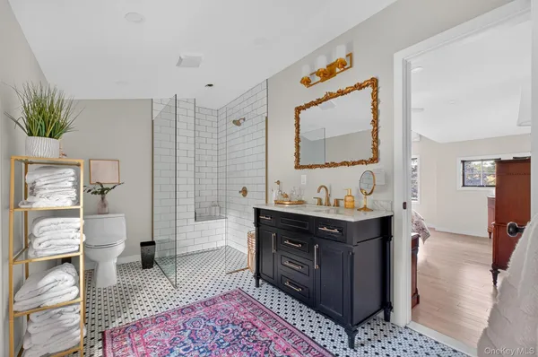 a spacious bathroom with a tub sink and mirror