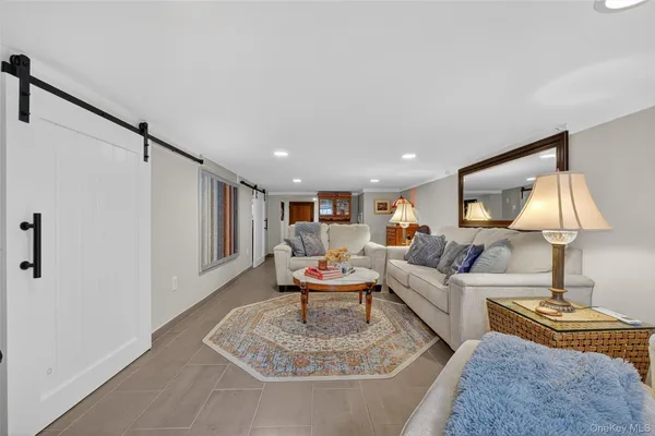 a living room with furniture and a lamp