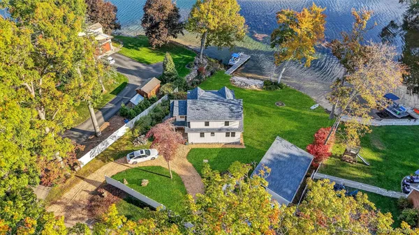 an aerial view of a house with yard swimming pool and outdoor seating