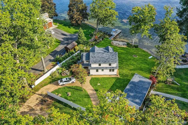 an aerial view of a house with a yard