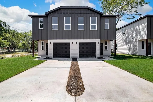 a view of a brick house with a yard