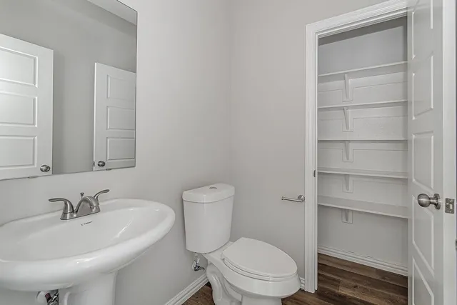a bathroom with a sink toilet and a mirror