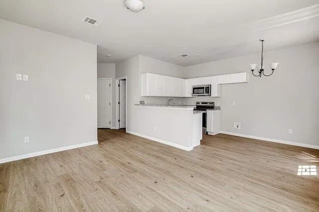 a view of a kitchen with wooden floor
