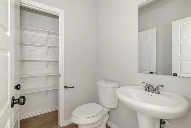 a bathroom with a sink toilet and a mirror