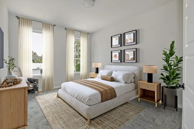 a bedroom with a large bed table and a window