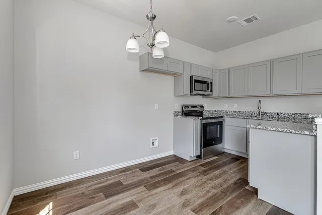 a kitchen with a refrigerator and microwave