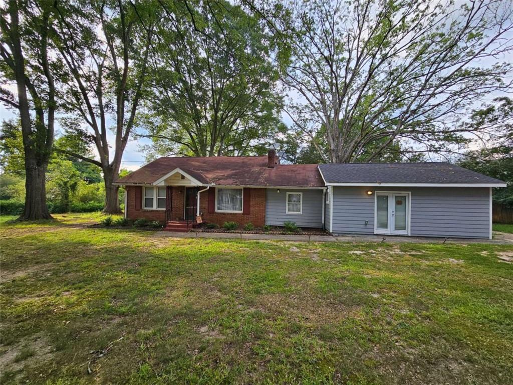 a front view of a house with yard and green space