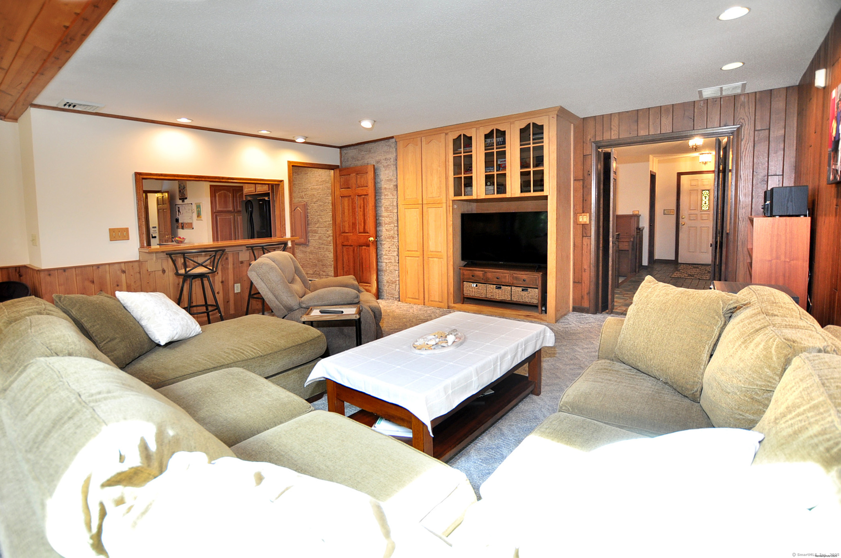 18 Fiano Road Bolton, CT 06043 - Photo 12 of 38 a living room with furniture flat screen tv and a fireplace