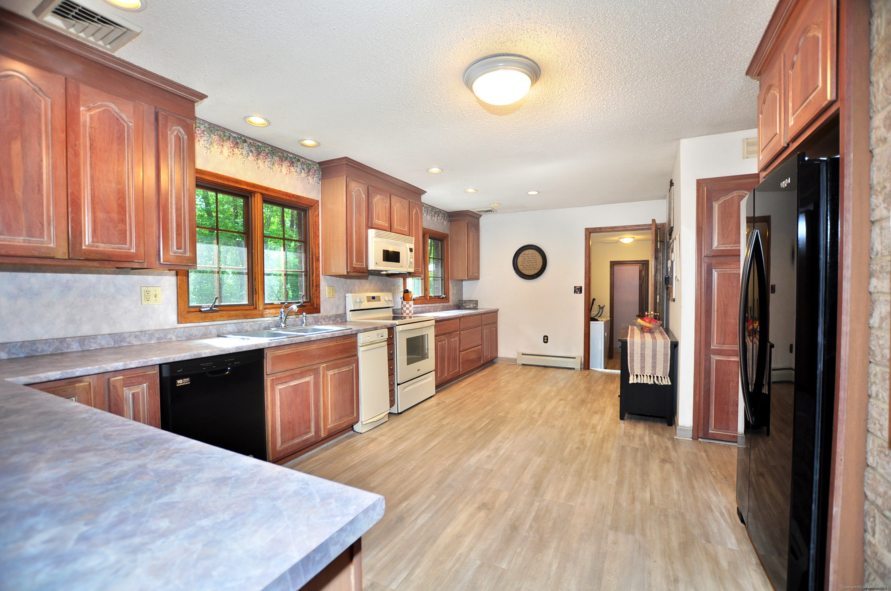 18 Fiano Road Bolton, CT 06043 - Photo 14 of 38 a large kitchen with stainless steel appliances granite countertop a refrigerator a sink dishwasher a stove and white countertops with wooden floor