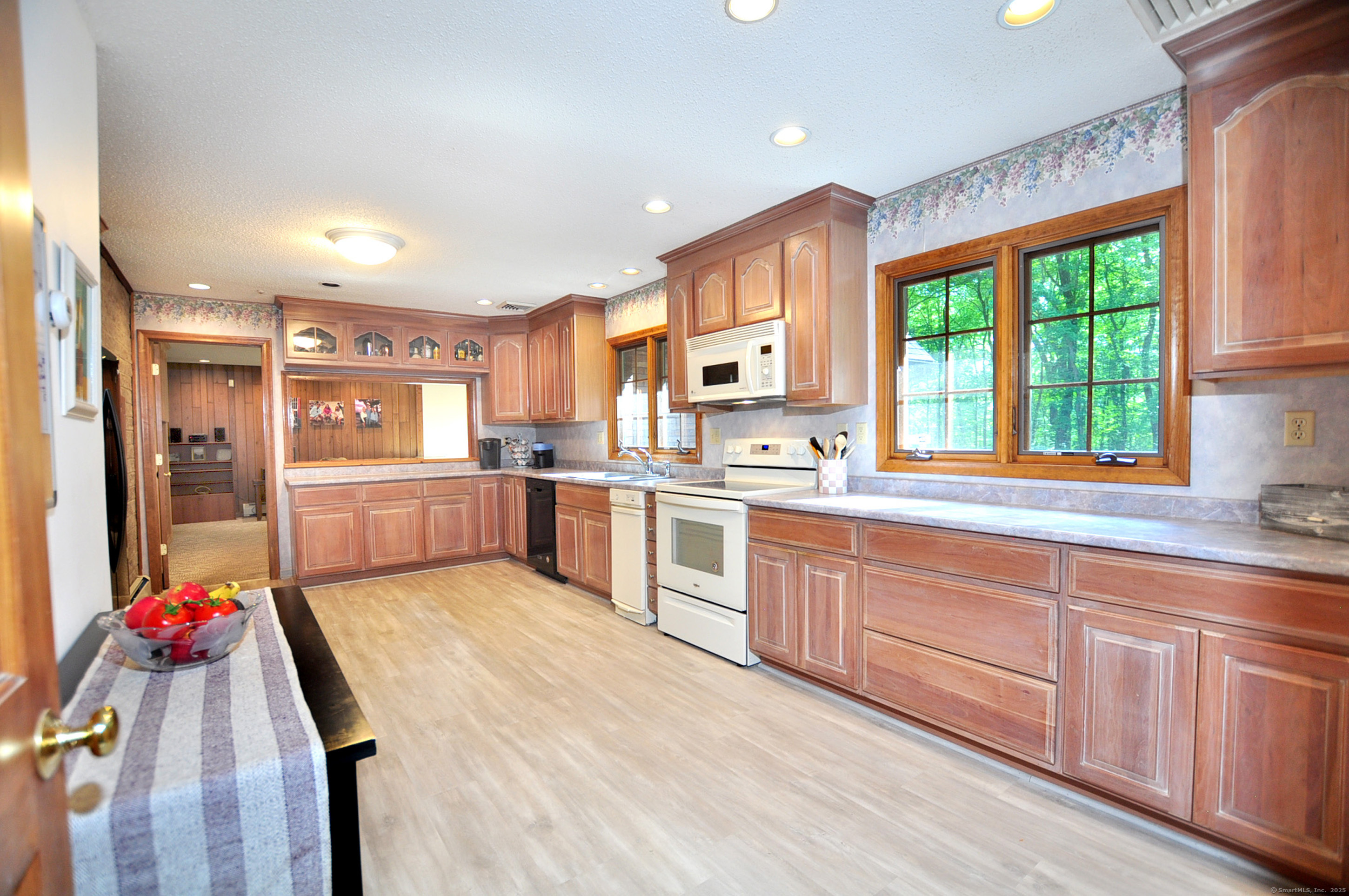 18 Fiano Road Bolton, CT 06043 - Photo 15 of 38 a large kitchen with stainless steel appliances granite countertop a large kitchen island a stove a sink dishwasher and a microwave oven with large wooden cabinets