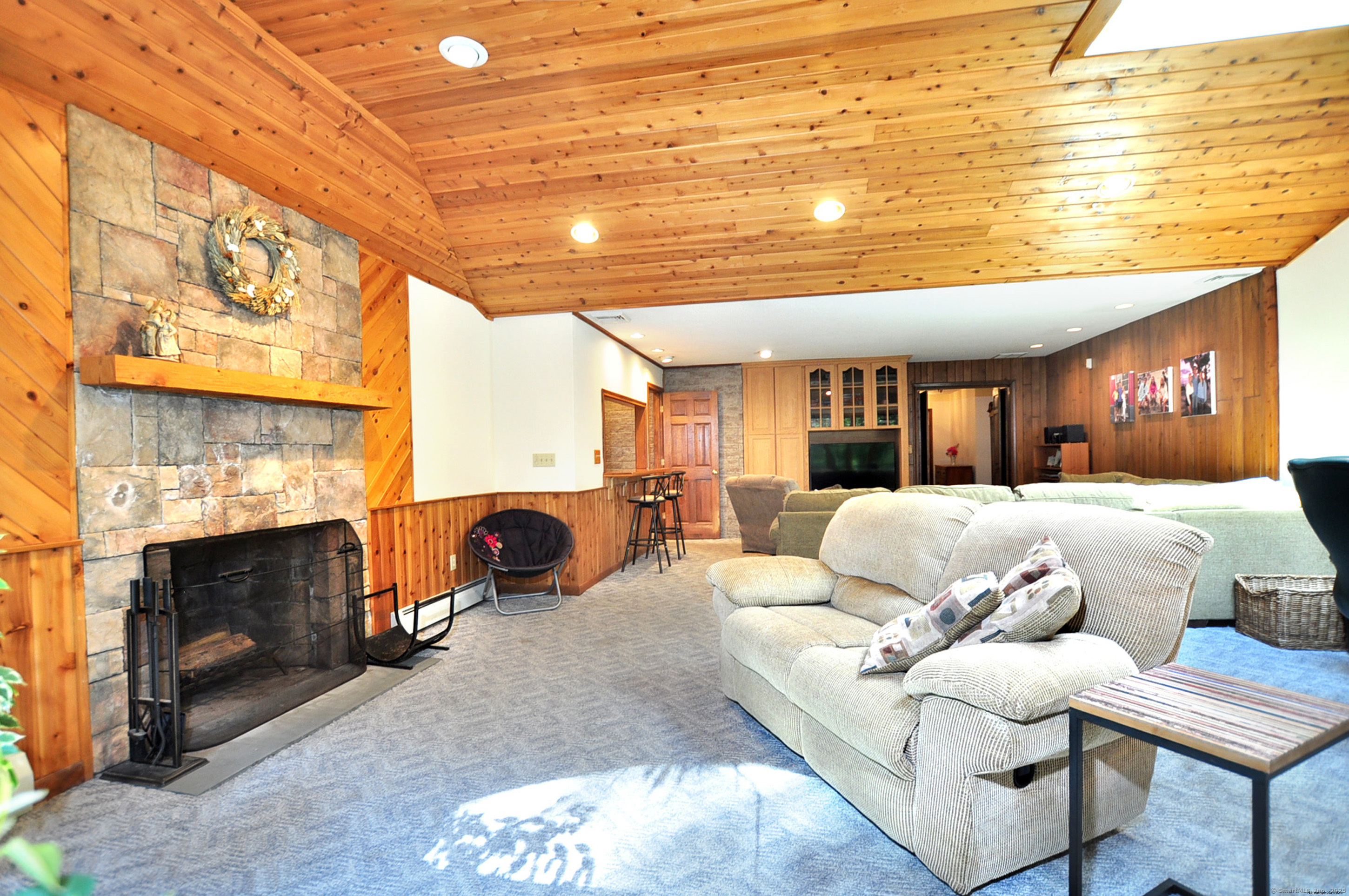 18 Fiano Road Bolton, CT 06043 - Photo 18 of 38 a living room with furniture a fireplace and a large window
